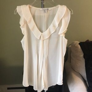 cream colored v-neck tank with collar, ruffles.